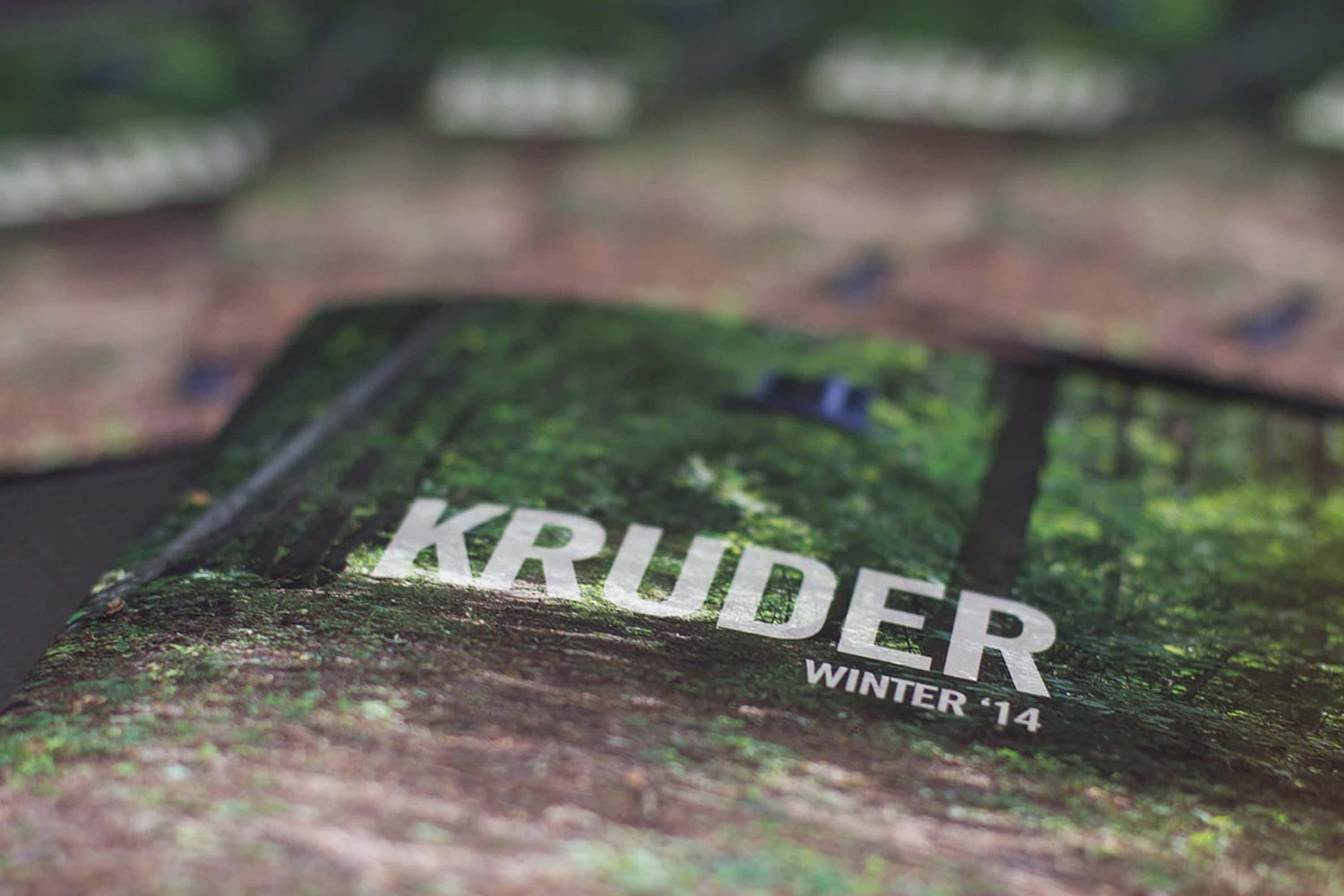 Close-up of the lookbook cover — Kruder, Winter '14 — over a forest path