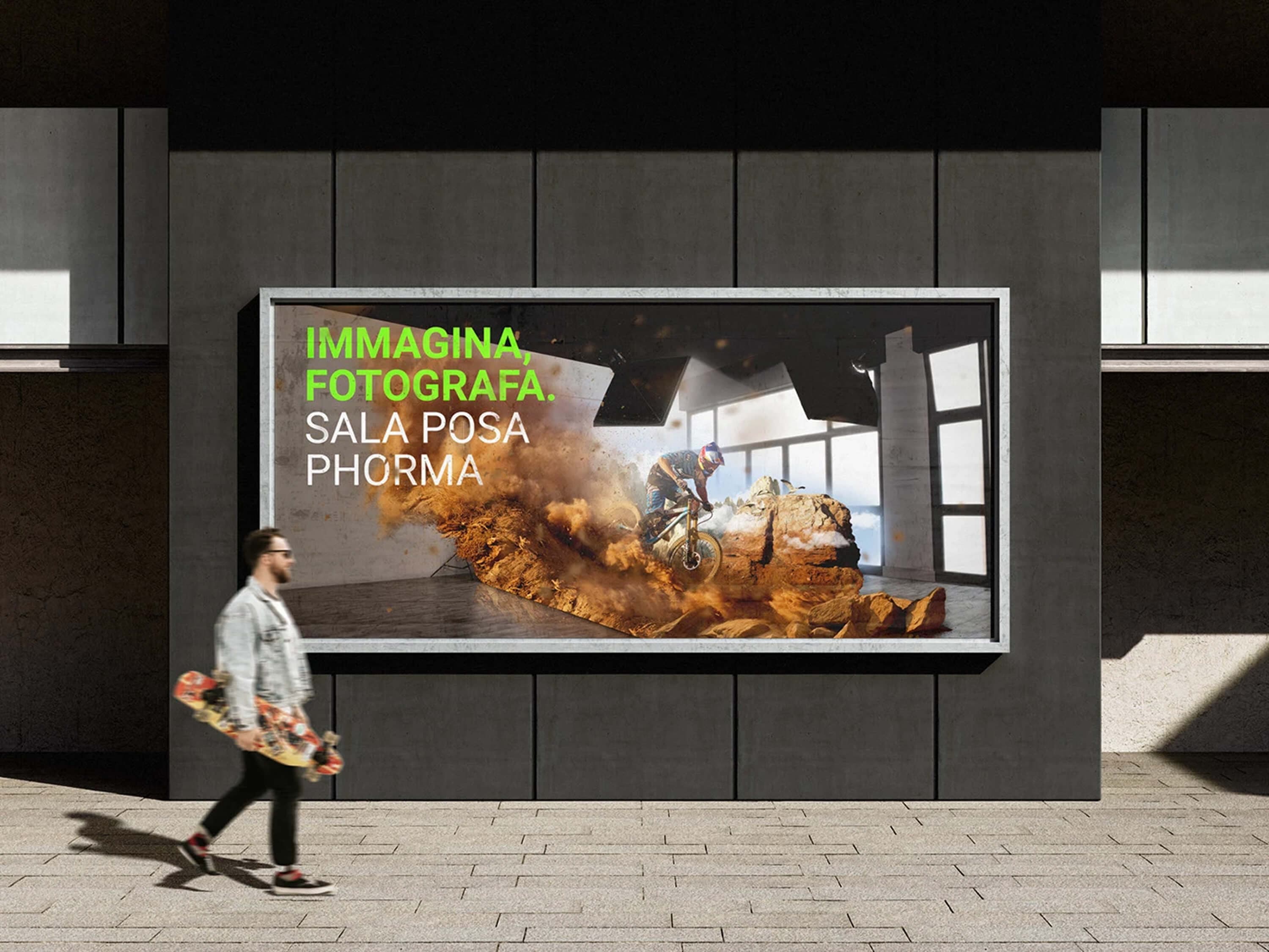 A second billboard on a city facade, a passer-by with a skateboard — a mountain biker bursting from the studio in a cloud of dust